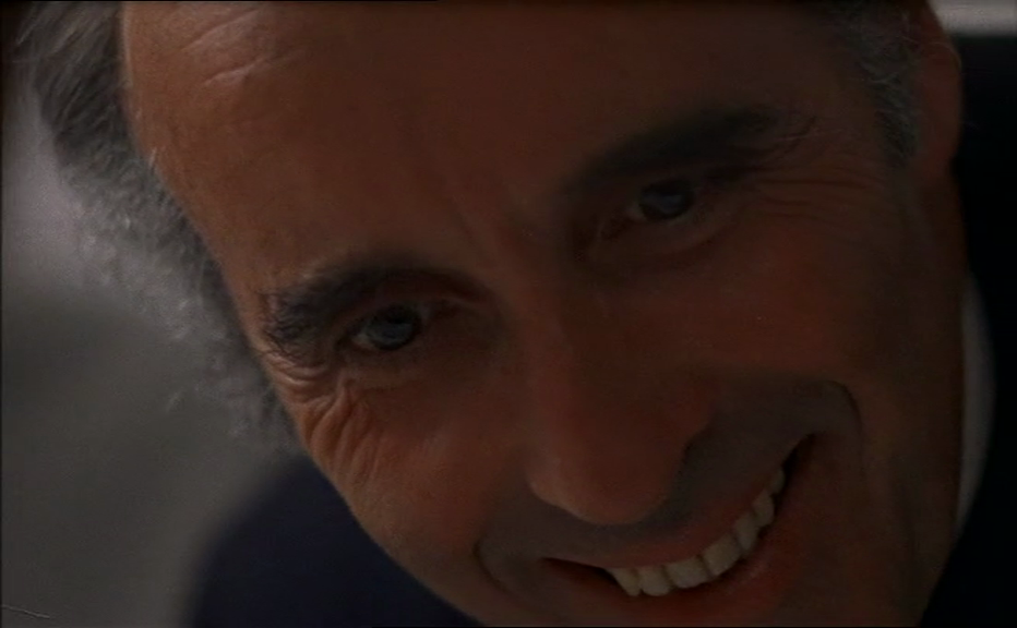 To the Devil a Daughter, scene of Lee leering Christopher Lee leers while others look on in dismay