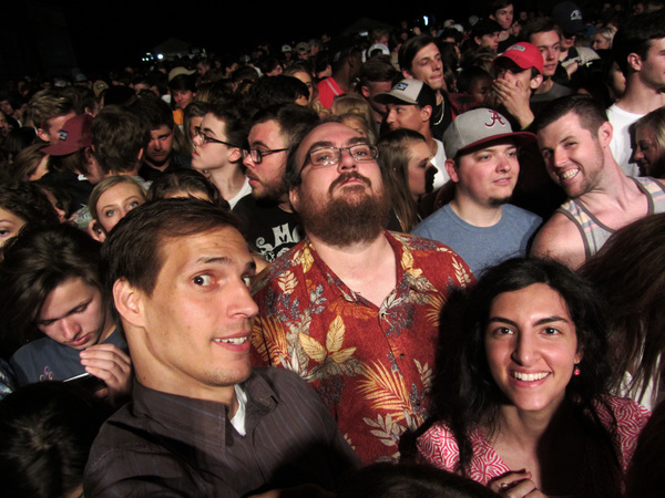 Tom, Doug, and Maryam surrounded by a packed crowd.